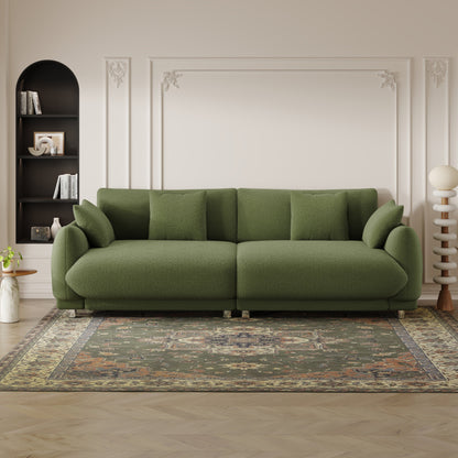 An 86.6-inch teddy wool green sofa with four throw pillows and hardware feet that can sit comfortably in an apartment bedroom wi